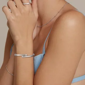 Open Bangle, gold-plated steel, silver, another view